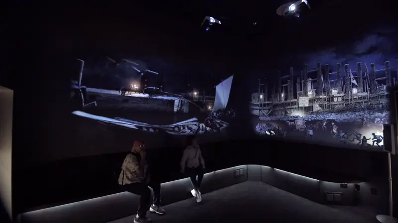 Visitors inside the French Quarter by Night projection room